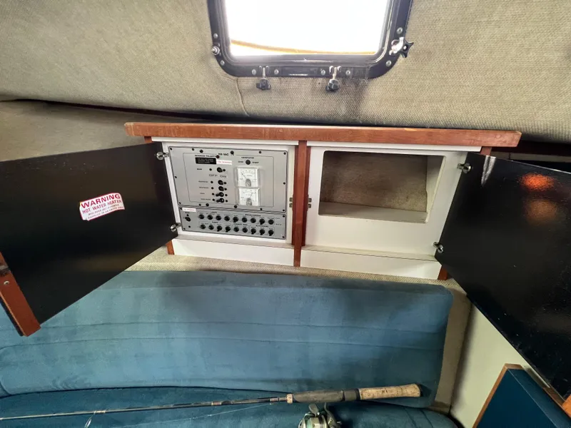 Slide: The Image of 1987 Carver Riviera 2807 interior with open cabinet and control panel. - 13