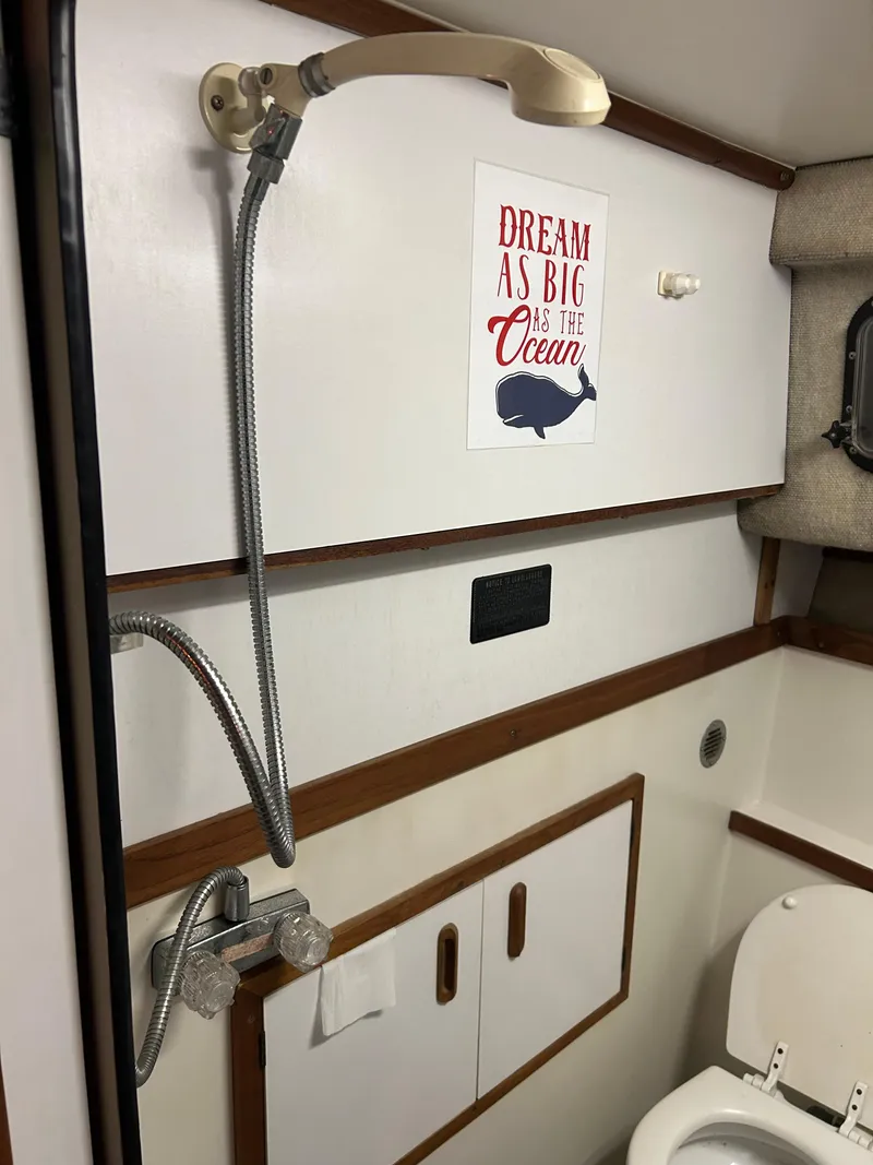 Slide: The Image of 1987 Carver Riviera 2807 bathroom with shower, toilet, and motivational ocean-themed decor. - 15