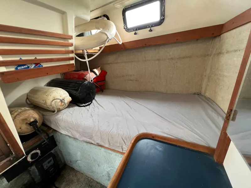 Slide: The Image of Interior cabin of 1987 Carver Riviera 2807 boat with bed and storage. - 18