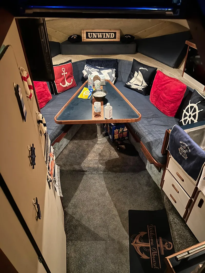 Slide: The Image of Cozy interior of 1987 Carver Riviera 2807 boat with nautical decor and seating area. - 8