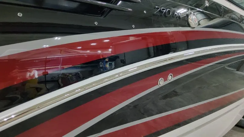 Slide: The Image of 2025 Formula 290 Bowrider boat with sleek red and black design. - 1