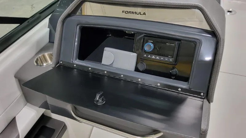 Slide: The Image of 2025 Formula 290 Bowrider dashboard with storage compartment and control panel. - 12