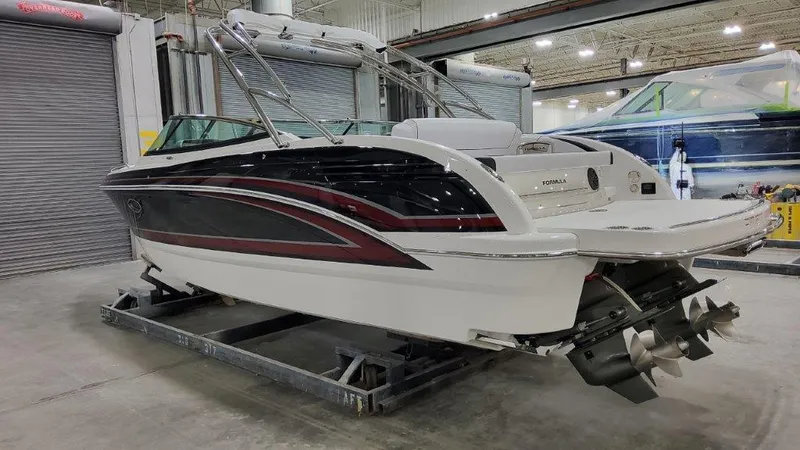 Slide: The Image of 2025 Formula 290 Bowrider boat in a warehouse setting. - 2