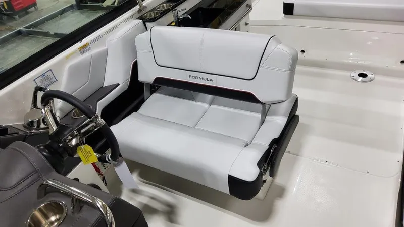 Slide: The Image of 2025 Formula 290 Bowrider interior with white seating and steering wheel. - 9