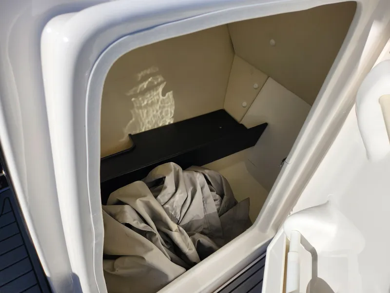 Slide: The Image of Storage compartment of 2016 Yamaha Boats 242 Limited S with cover inside. - 13