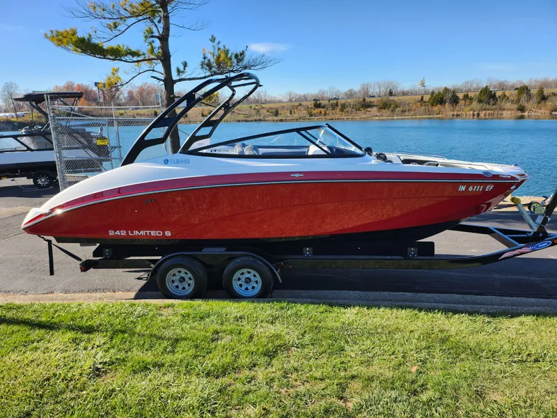 Slide: The Image of 2016 Yamaha Boats 242 Limited S on trailer by a lake. - 9