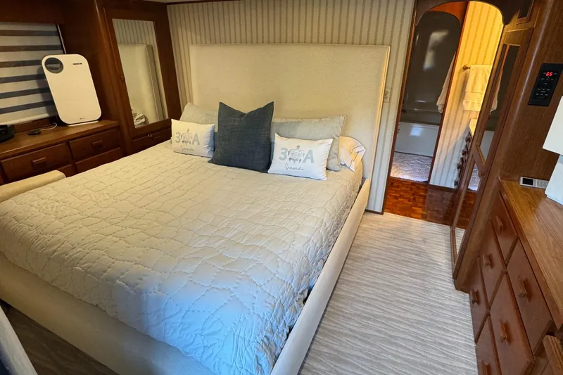 Slide: The Image of Cozy bedroom in 1997 Lazy Days River Cruiser with elegant wood furnishings and plush bedding. - 10
