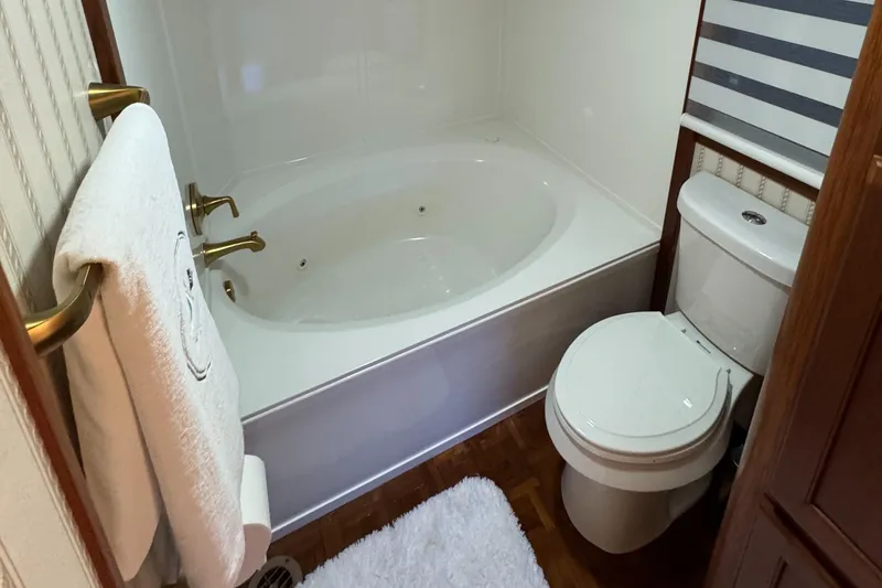 Slide: The Image of Bathroom in 1997 Lazy Days River Cruiser with tub, toilet, and towel rack. - 12