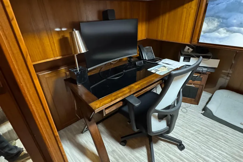 Slide: The Image of Home office setup on 1997 Lazy Days River Cruiser with desk, chair, and computer. - 16