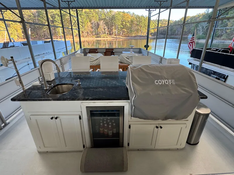 Slide: The Image of 1997 Lazy Days River Cruiser with outdoor kitchen and scenic lake view. - 19
