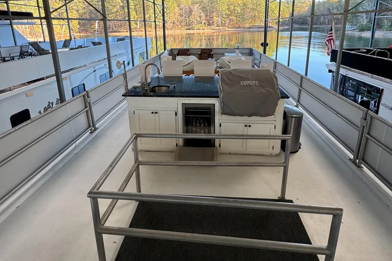 Slide: The Image of 1997 Lazy Days River Cruiser with outdoor kitchen on a serene dock. - 20