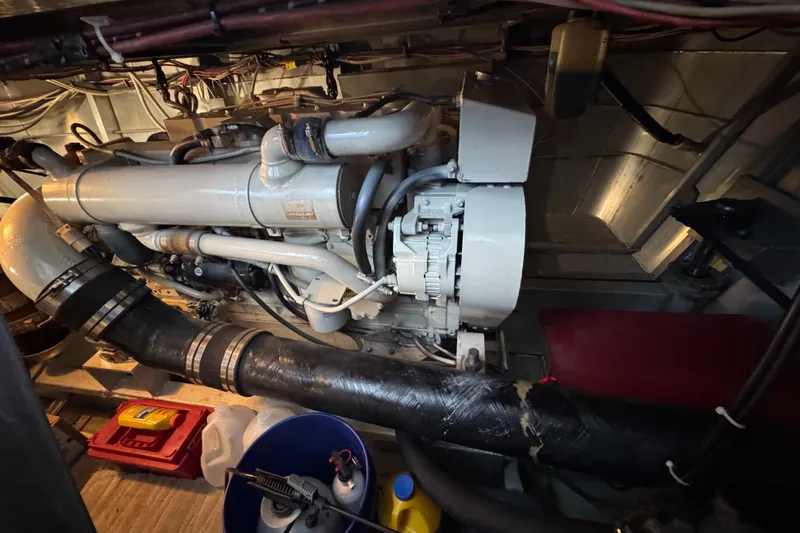 Slide: The Image of Engine room of a 1997 Lazy Days River Cruiser with visible machinery and equipment. - 24