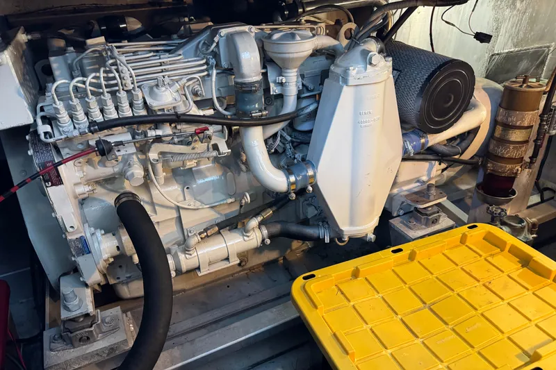 Slide: The Image of Engine of a 1997 Lazy Days River Cruiser with yellow storage lid nearby. - 25