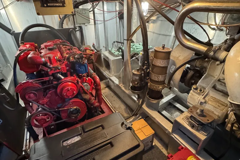 Slide: The Image of Engine room of a 1997 Lazy Days River Cruiser with visible machinery and components. - 26