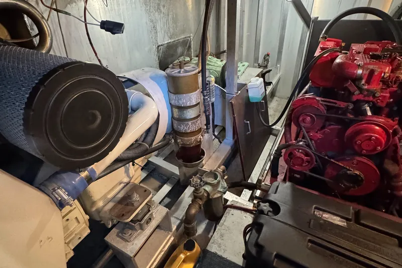 Slide: The Image of Engine room of a 1997 Lazy Days River Cruiser with visible machinery and components. - 27