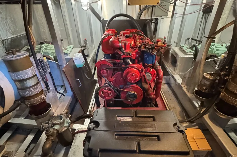 Slide: The Image of Engine room of a 1997 Lazy Days River Cruiser with a red engine. - 28