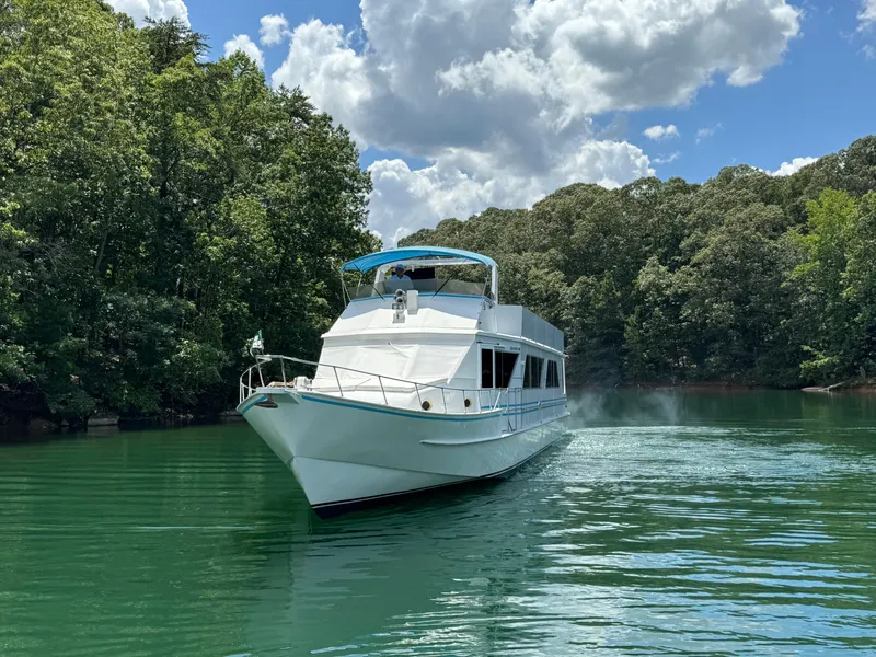 Slide: The Image of 1997 Lazy Days River Cruiser on a serene, tree-lined waterway under a partly cloudy sky. - 3