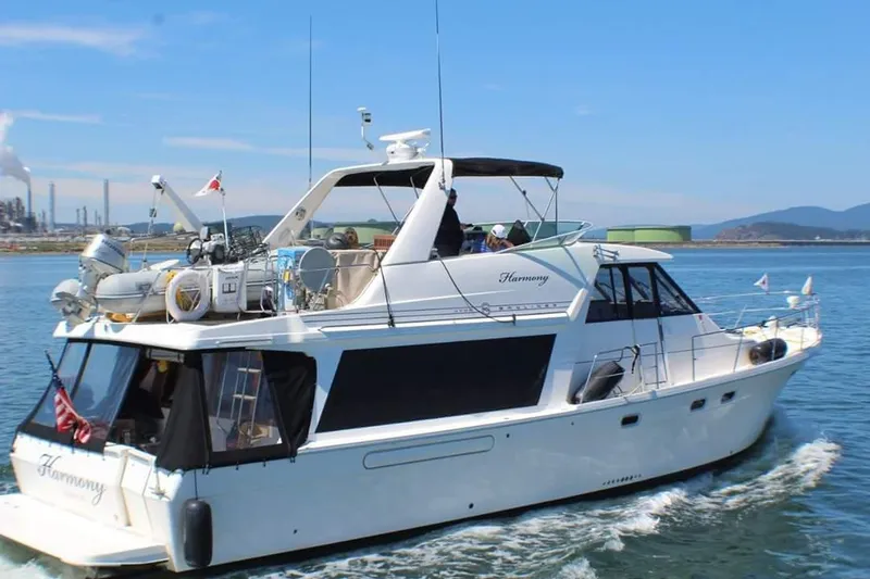 The Image of 1995 Bayliner 4788 Pilot House Motoryacht cruising on a sunny day. - 0