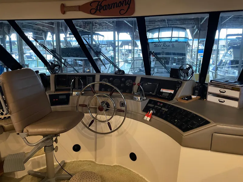 Slide: The Image of 1995 Bayliner 4788 Pilot House Motoryacht helm with steering wheel and navigation controls. - 11