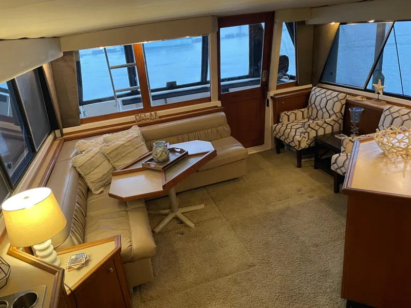 Slide: The Image of Luxurious interior of 1995 Bayliner 4788 Pilot House Motoryacht with cozy seating and elegant decor. - 13