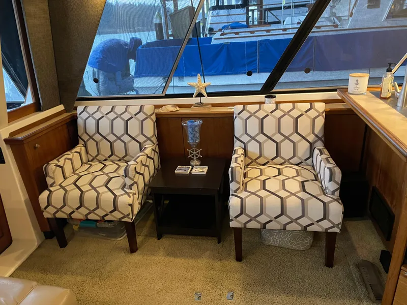 Slide: The Image of Interior of 1995 Bayliner 4788 Pilot House Motoryacht with patterned chairs and table. - 20