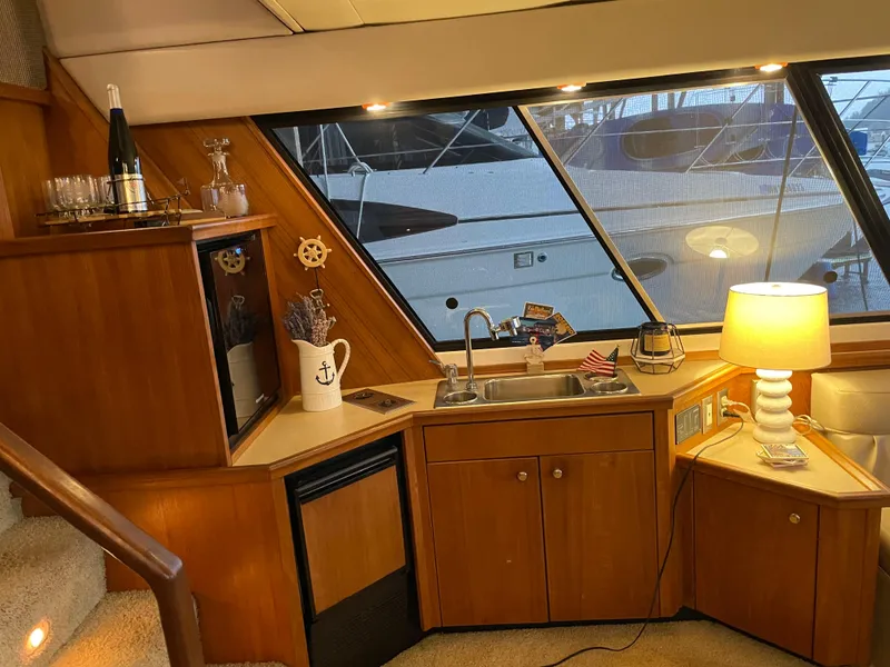 Slide: The Image of Interior of 1995 Bayliner 4788 Pilot House Motoryacht with kitchenette and nautical decor. - 23