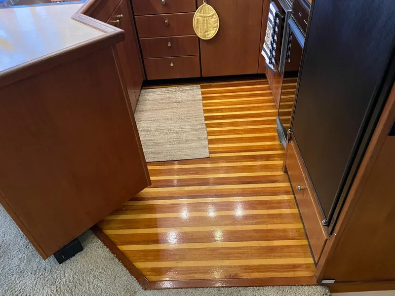 Slide: The Image of 1995 Bayliner 4788 Pilot House Motoryacht interior with polished wood flooring and cabinetry. - 28