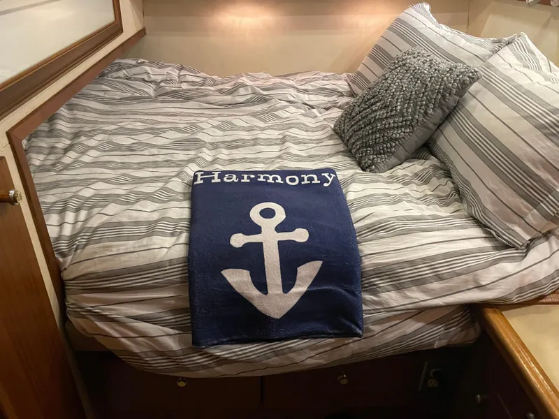 Slide: The Image of Cozy bedroom in 1995 Bayliner 4788 Pilot House Motoryacht with nautical-themed decor. - 30