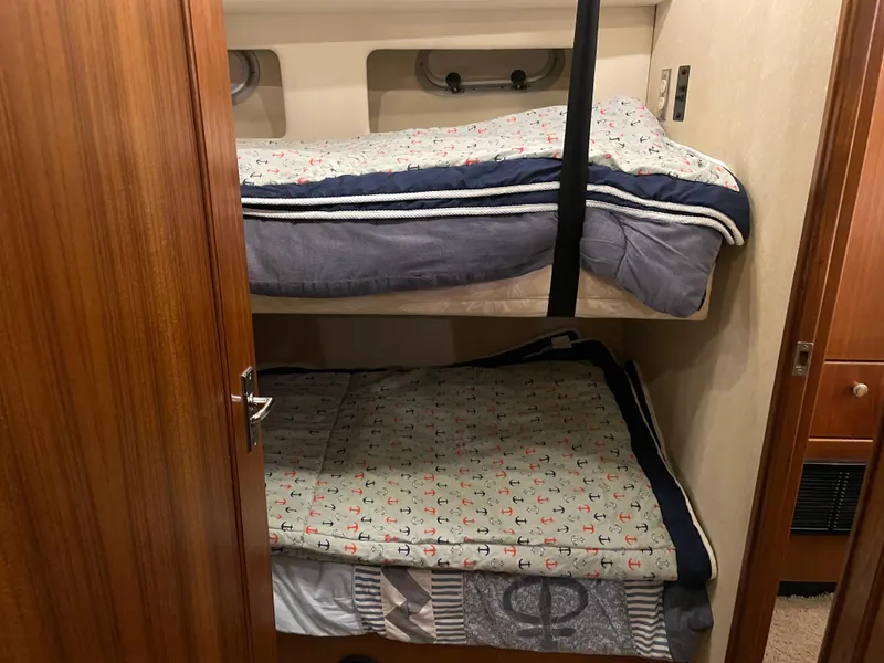 Slide: The Image of Bunk beds in 1995 Bayliner 4788 Pilot House Motoryacht cabin, featuring cozy bedding. - 37