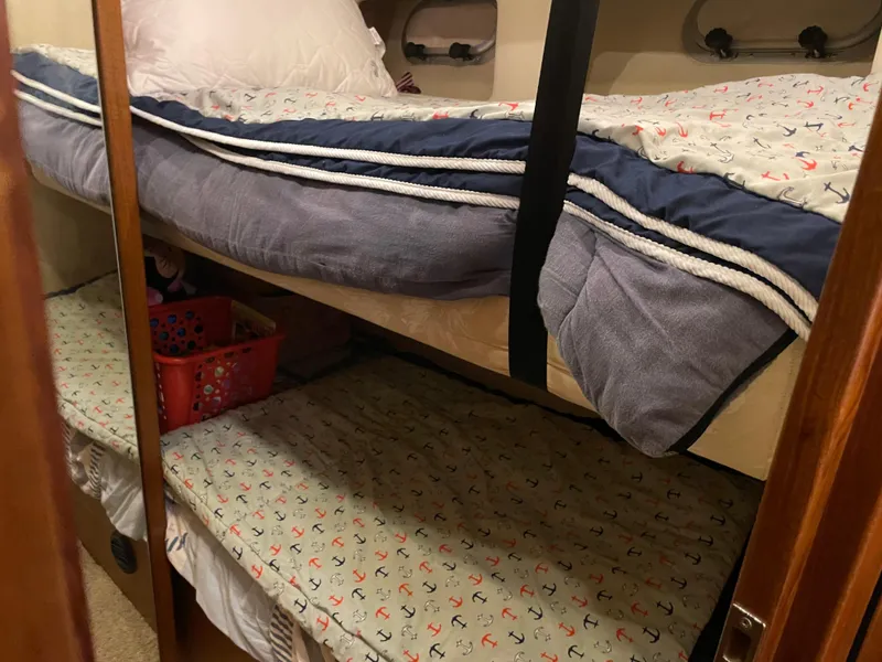 Slide: The Image of Bunk beds in 1995 Bayliner 4788 Pilot House Motoryacht cabin with nautical-themed bedding. - 38