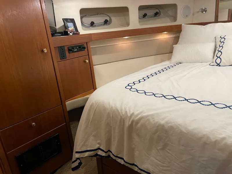 Slide: The Image of Cozy bedroom interior of 1995 Bayliner 4788 Pilot House Motoryacht with elegant bedding. - 40