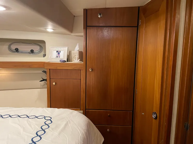 Slide: The Image of Cozy cabin interior of 1995 Bayliner 4788 Pilot House Motoryacht with wooden cabinetry and bed. - 43