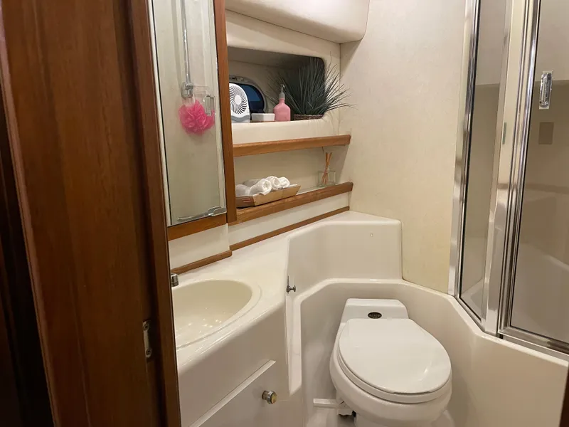 Slide: The Image of Bathroom interior of 1995 Bayliner 4788 Pilot House Motoryacht, featuring sink, toilet, and shower. - 44