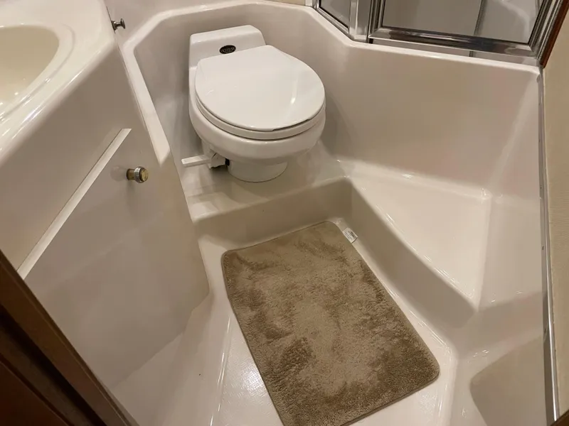 Slide: The Image of Bathroom interior of 1995 Bayliner 4788 Pilot House Motoryacht with toilet and beige mat. - 47