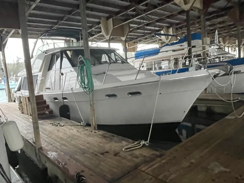 Slide: The Image of 1995 Bayliner 4788 Pilot House Motoryacht docked in a covered marina. - 8