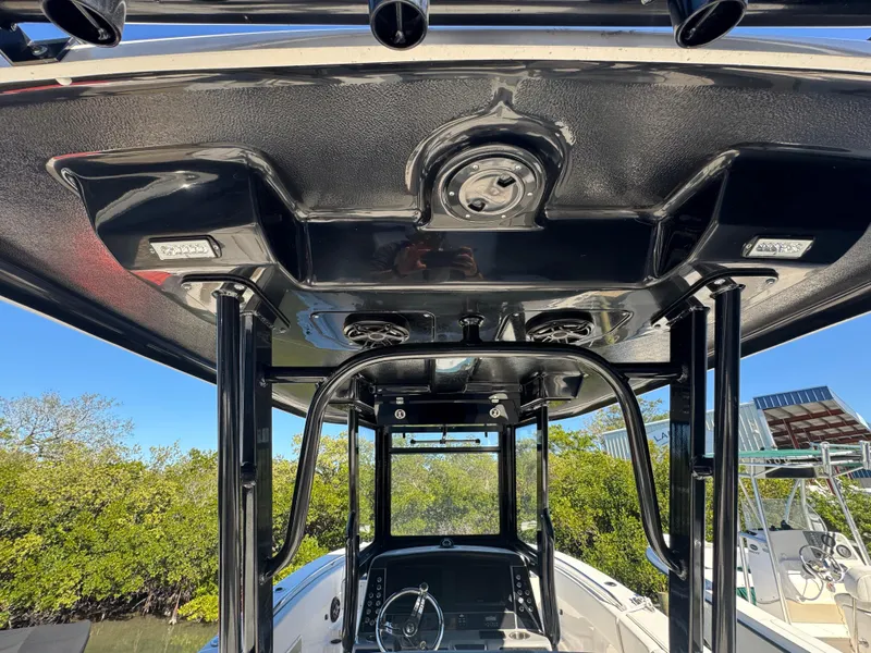 Slide: The Image of 2023 Robalo R270 Center Console boat interior with sleek black T-top design. - 17
