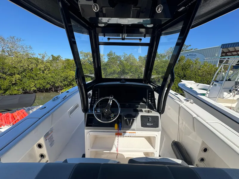 Slide: The Image of 2023 Robalo R270 Center Console boat interior with steering wheel and dashboard. - 22