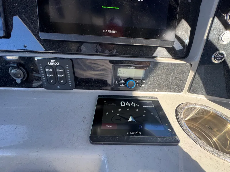 Slide: The Image of 2023 Robalo R270 Center Console dashboard with Garmin navigation and Clarion audio system. - 29