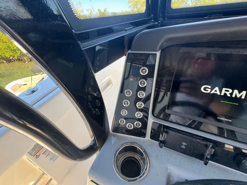 Slide: The Image of 2023 Robalo R270 Center Console dashboard with Garmin display and control panel. - 31