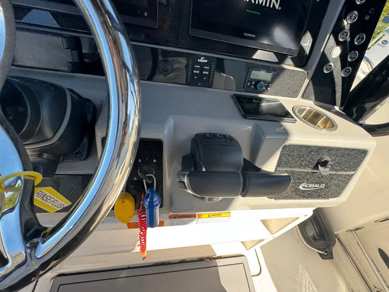 Slide: The Image of 2023 Robalo R270 Center Console dashboard with steering wheel and controls. - 32