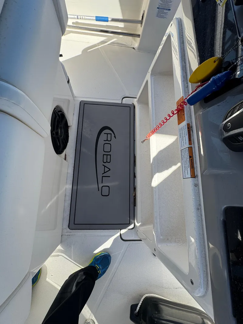 Slide: The Image of 2023 Robalo R270 Center Console boat interior with branded flooring and seating. - 33