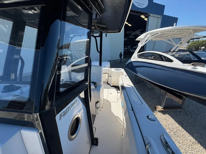 Slide: The Image of 2023 Robalo R270 Center Console boat at marina, side view. - 36