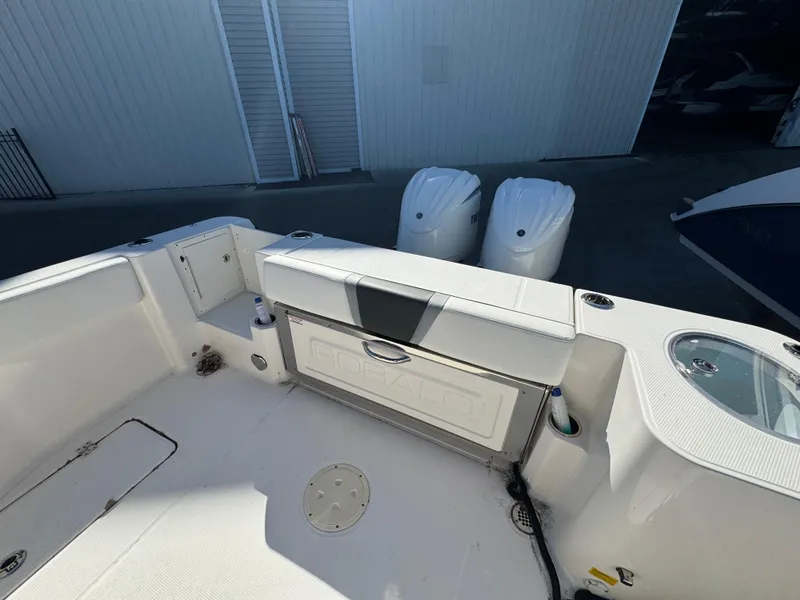 Slide: The Image of 2023 Robalo R270 Center Console boat interior with dual engines and seating area. - 39