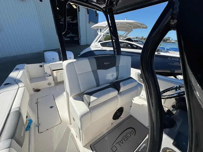 Slide: The Image of 2023 Robalo R270 Center Console boat interior with seating and steering area. - 45