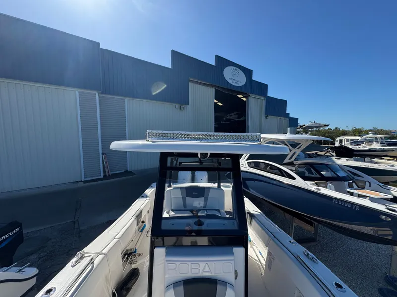 Slide: The Image of 2023 Robalo R270 Center Console boat at marina, sunny day. - 46