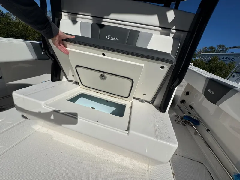 Slide: The Image of 2023 Robalo R270 Center Console boat storage compartment open. - 48