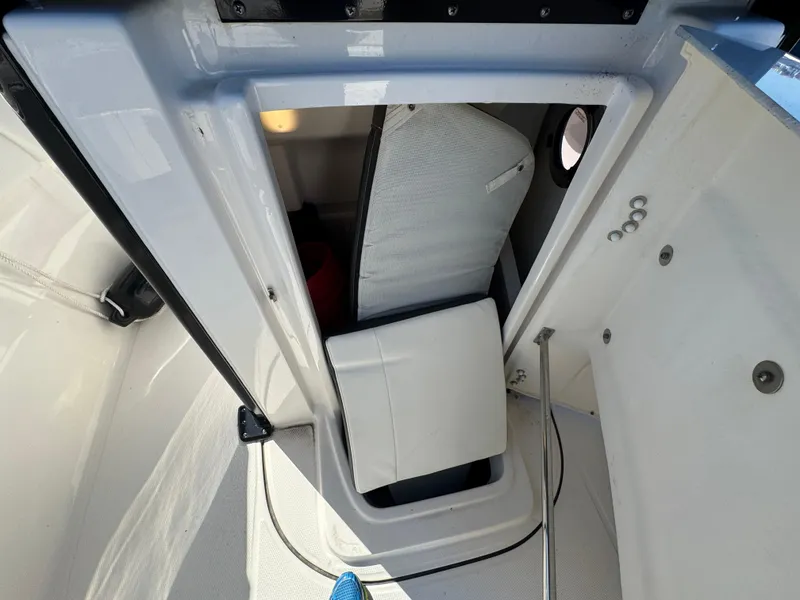 Slide: The Image of 2023 Robalo R270 Center Console interior storage compartment with cushion and hatch. - 49