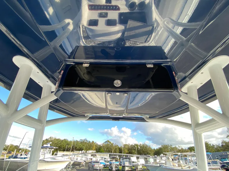 Slide: The Image of 2020 Glasstream 280 Pro-XS boat console with overhead storage, marina view. - 19