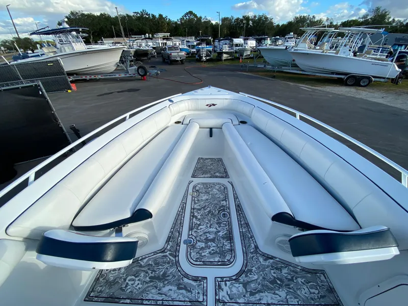 Slide: The Image of 2020 Glasstream 280 Pro-XS boat with spacious seating and stylish design at a marina. - 24