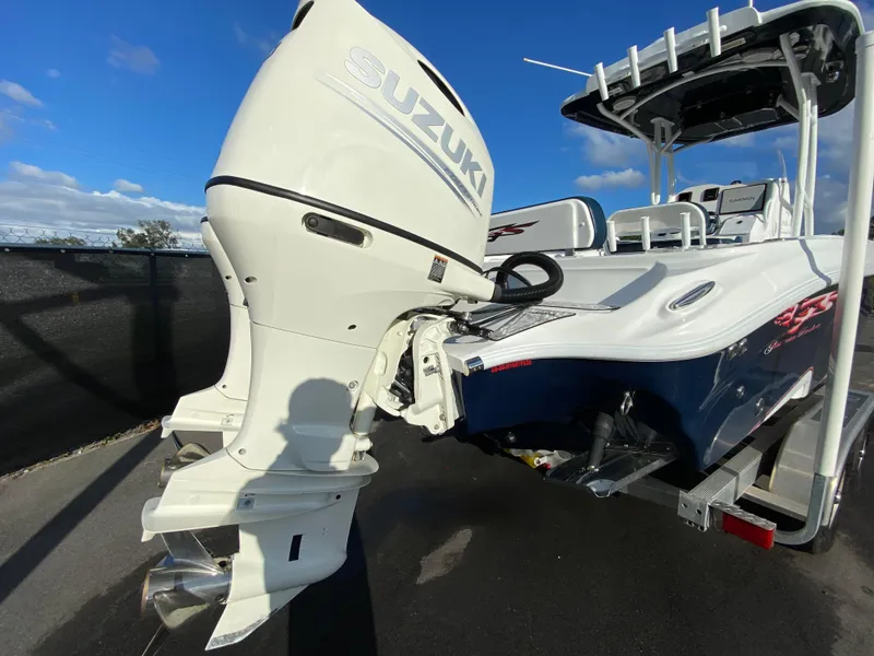 Slide: The Image of 2020 Glasstream 280 Pro-XS boat with Suzuki outboard motor, parked on a sunny day. - 3